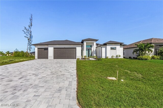 1517 SW 28th Ter, Cape Coral, FL 33914 - prairie-style home featuring a garage and a front lawn