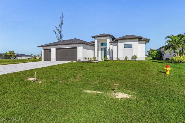 1517 SW 28th Ter, Cape Coral, FL 33914 - prairie-style house featuring a front yard and a garage