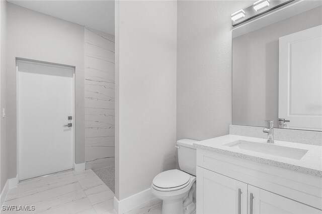 1517 SW 28th Ter, Cape Coral, FL 33914 - bathroom featuring toilet, vanity, and tiled shower