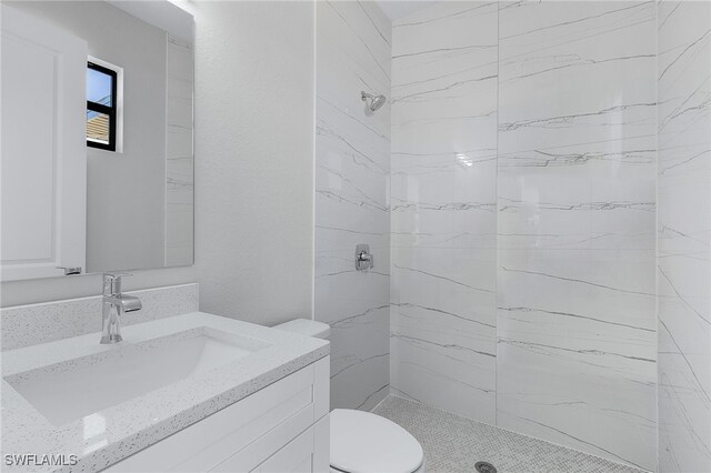 1517 SW 28th Ter, Cape Coral, FL 33914 - bathroom featuring vanity, toilet, and tiled shower