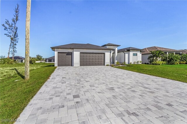 1517 SW 28th Ter, Cape Coral, FL 33914 - prairie-style house featuring a garage and a front lawn