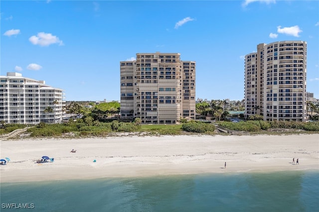 view of property featuring a beach view and a water view