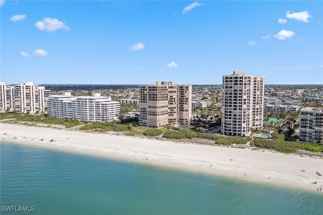 bird's eye view featuring a water view and a beach view