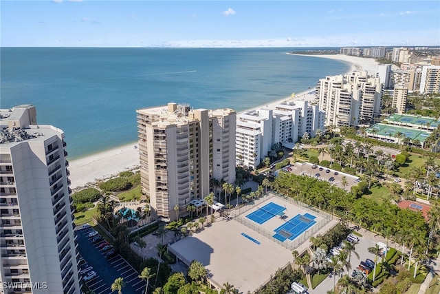 bird's eye view with a water view and a beach view