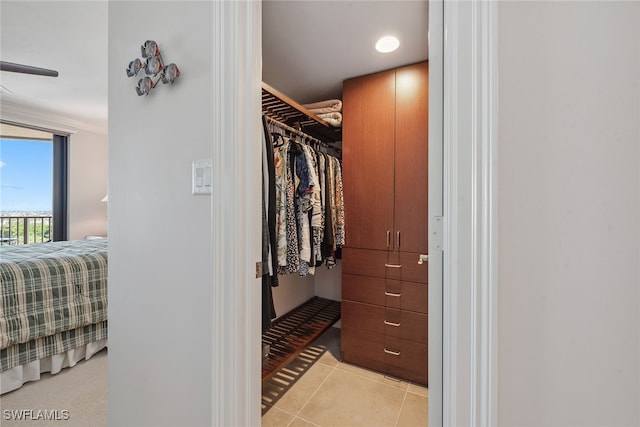 spacious closet with light tile patterned floors