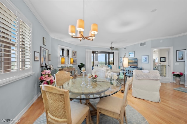 dining space featuring ceiling fan with notable chandelier, light hardwood / wood-style flooring, and ornamental molding