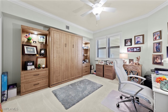 carpeted home office with crown molding and ceiling fan