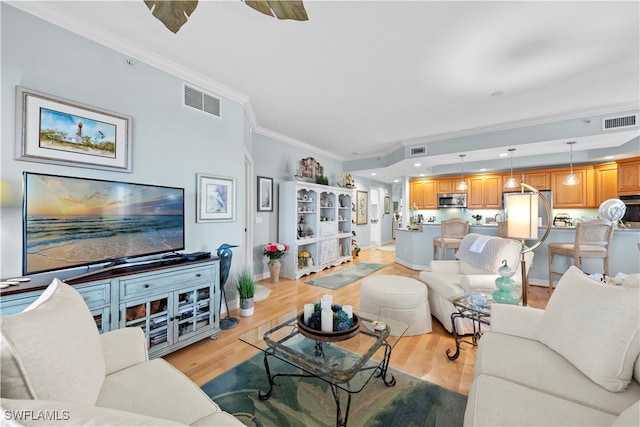 living room featuring light hardwood / wood-style floors and ornamental molding