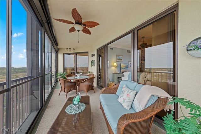 sunroom featuring ceiling fan and a healthy amount of sunlight