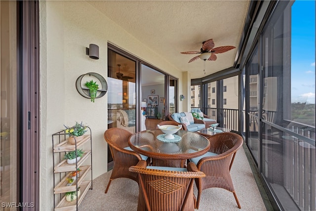 sunroom / solarium featuring ceiling fan