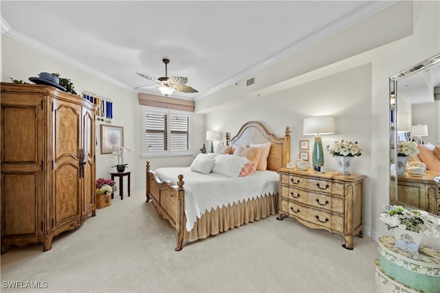 carpeted bedroom with ceiling fan and ornamental molding