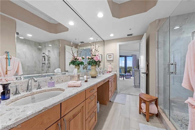 bathroom with vanity and a shower with shower door