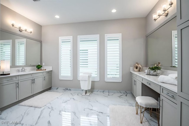 bathroom with marble finish floor, recessed lighting, and vanity