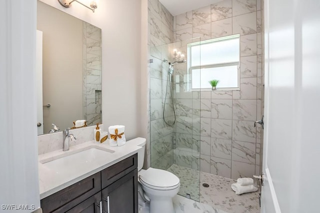 bathroom featuring a walk in shower, vanity, and toilet