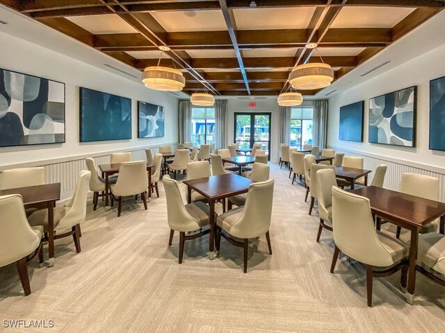 dining space featuring wainscoting, coffered ceiling, and beam ceiling