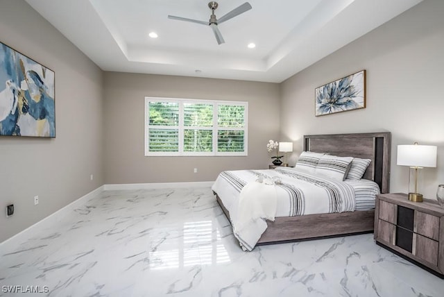 bedroom with marble finish floor, recessed lighting, a raised ceiling, a ceiling fan, and baseboards