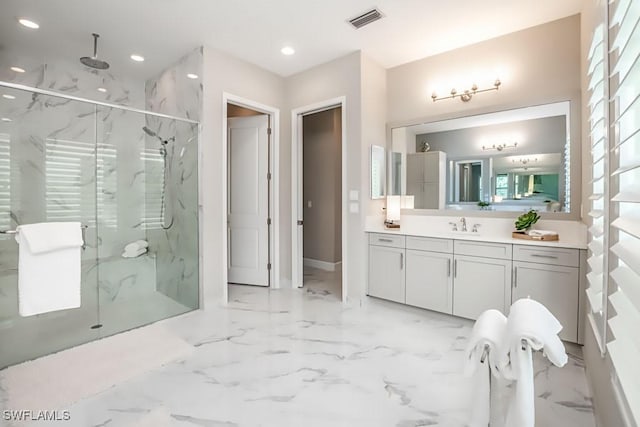 full bathroom with marble finish floor, a marble finish shower, recessed lighting, visible vents, and vanity