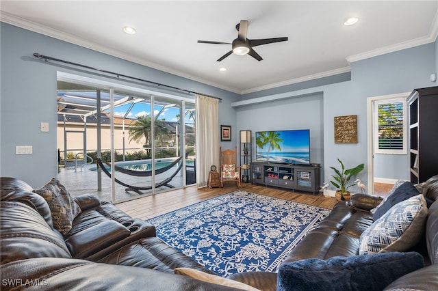 living room featuring a sunroom, ceiling fan, ornamental molding, wood finished floors, and recessed lighting