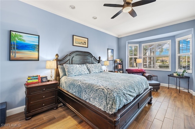 bedroom featuring ornamental molding, wood finished floors, a ceiling fan, and baseboards