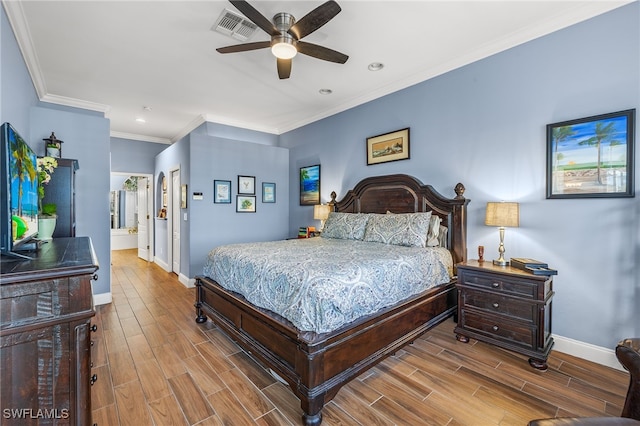 bedroom with wood finish floors, a closet, visible vents, ornamental molding, and baseboards