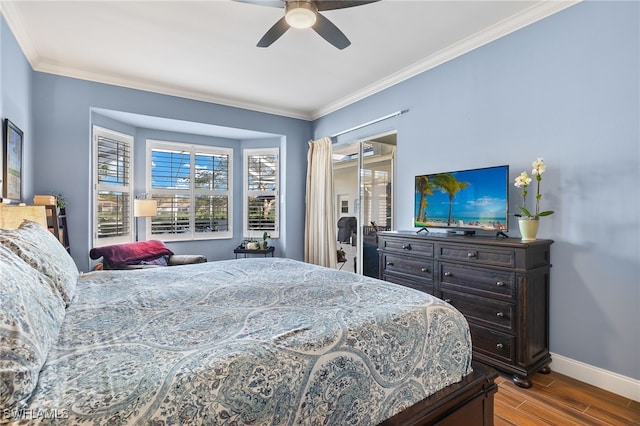 bedroom featuring ceiling fan, crown molding, baseboards, and wood finished floors