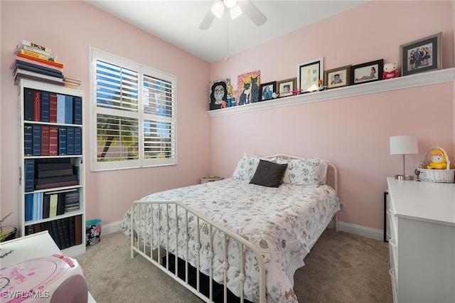 carpeted bedroom featuring ceiling fan and baseboards