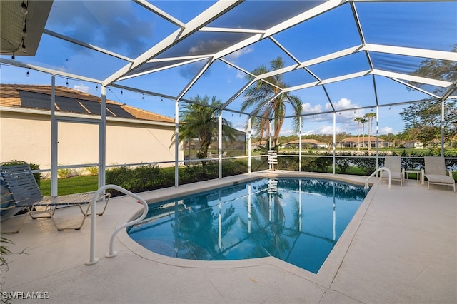 outdoor pool with a patio and a lanai