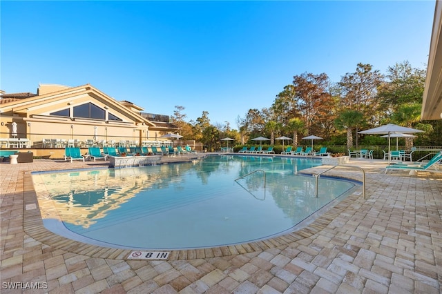 community pool with a patio area