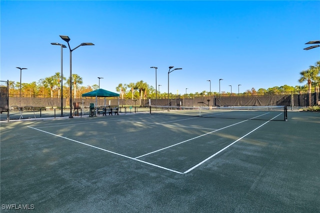 view of sport court featuring fence