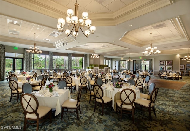 dining area featuring crown molding, a raised ceiling, and an inviting chandelier