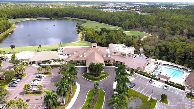 birds eye view of property featuring a forest view, golf course view, and a water view