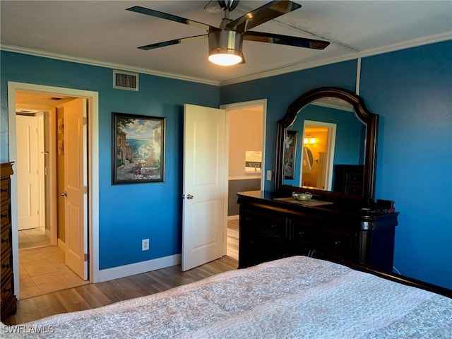 bedroom with hardwood / wood-style floors, ceiling fan, and ornamental molding