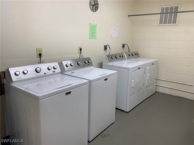 clothes washing area featuring independent washer and dryer