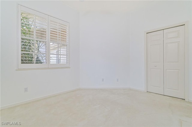 unfurnished bedroom with light colored carpet