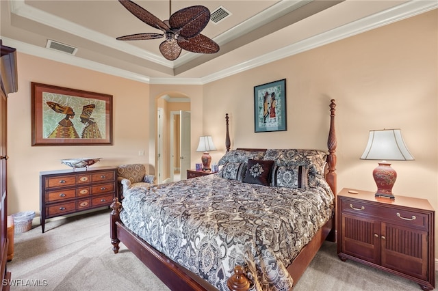 bedroom featuring a raised ceiling, ceiling fan, crown molding, and light carpet