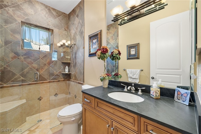 bathroom with vanity, an enclosed shower, and toilet