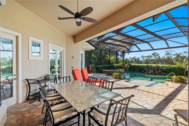 view of patio featuring ceiling fan, a swimming pool with hot tub, a lanai, and french doors