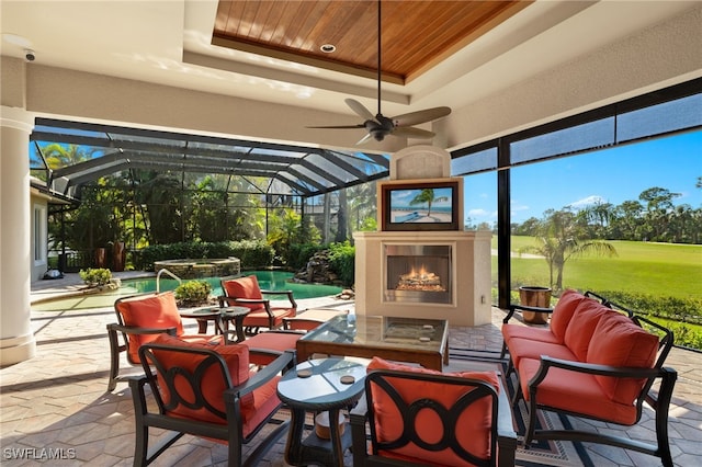 view of patio featuring an outdoor living space with a fireplace and ceiling fan