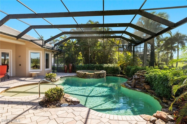 view of swimming pool featuring an in ground hot tub, a patio, and glass enclosure