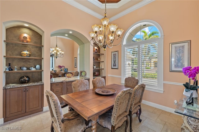 dining room featuring built in shelves, an inviting chandelier, and ornamental molding