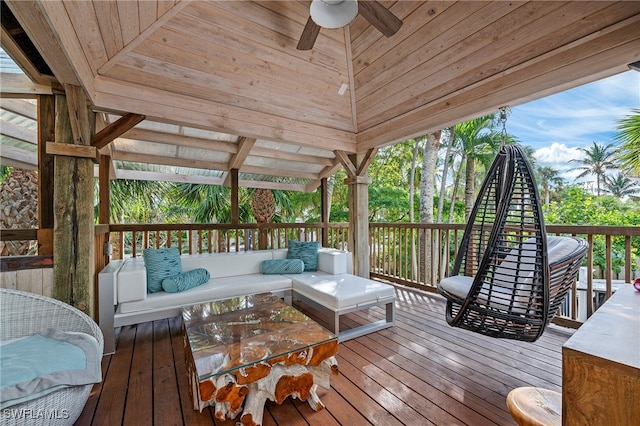 deck with ceiling fan and an outdoor living space