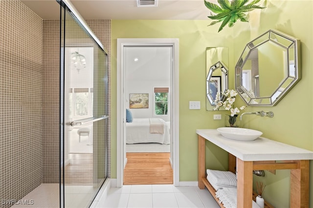 bathroom with tile patterned floors, vanity, and a shower with shower door