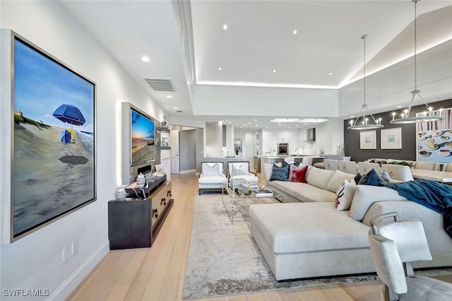 living room featuring light hardwood / wood-style floors and vaulted ceiling