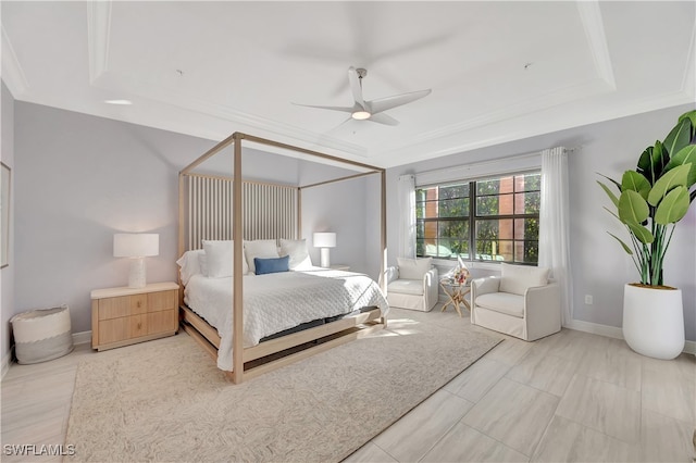 bedroom featuring ceiling fan, crown molding, and a tray ceiling