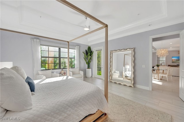 bedroom with a chandelier, a raised ceiling, and ornamental molding