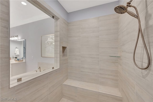 bathroom featuring vanity and tiled shower