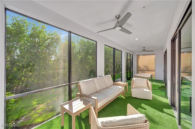 unfurnished sunroom featuring ceiling fan