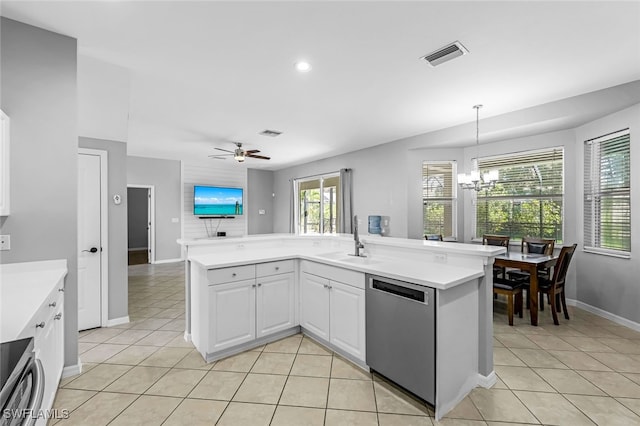 kitchen with white cabinets, ceiling fan with notable chandelier, sink, appliances with stainless steel finishes, and a healthy amount of sunlight