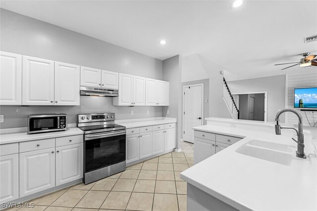 kitchen with white cabinets, sink, ceiling fan, light tile patterned flooring, and stainless steel appliances