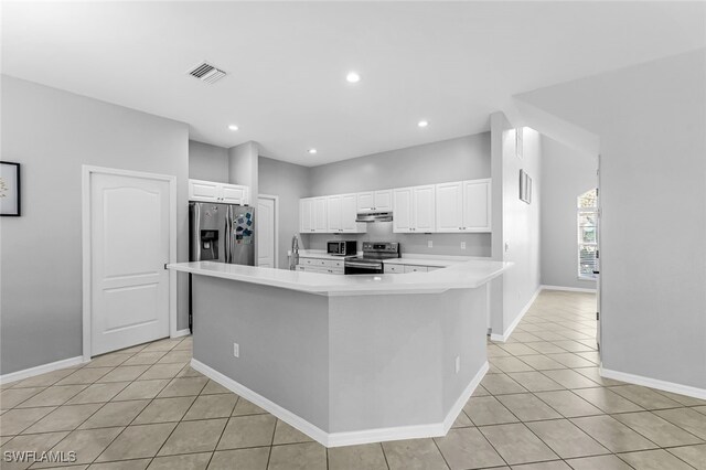 kitchen featuring a large island, white cabinets, light tile patterned floors, and appliances with stainless steel finishes